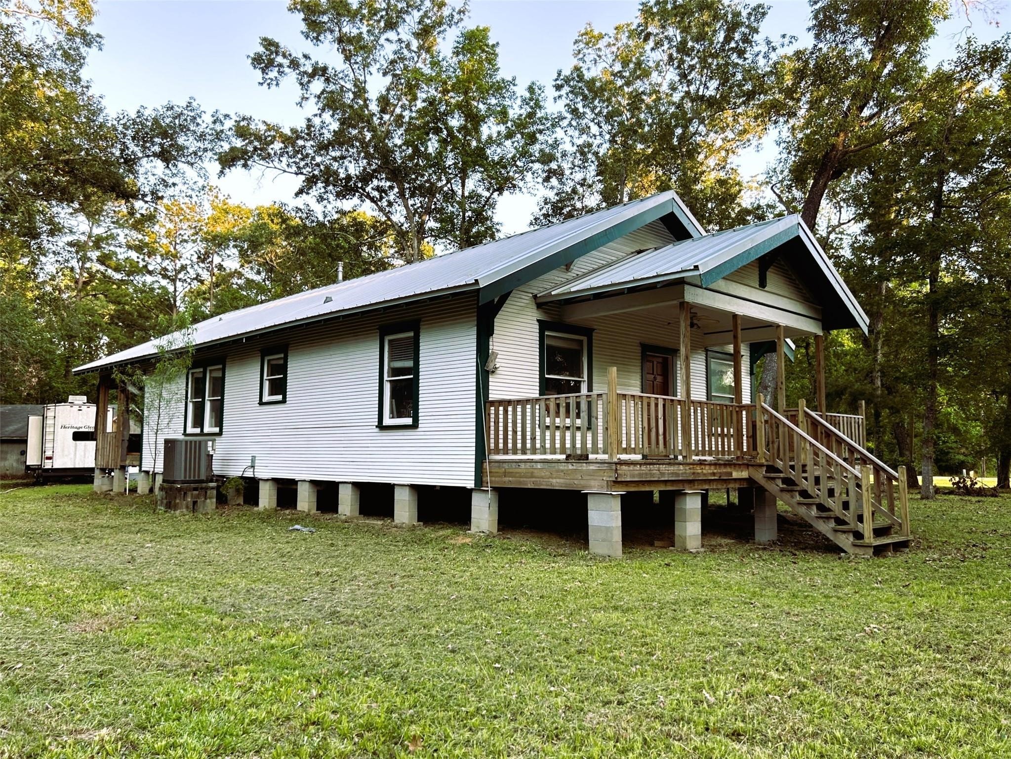 877 County Road 6474 Dayton, TX 77535 - Photo 3 of 27 a view of a house with a yard