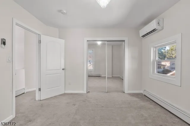 an empty room with windows and closet