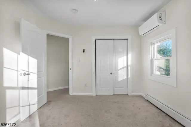 an empty room with windows and closet
