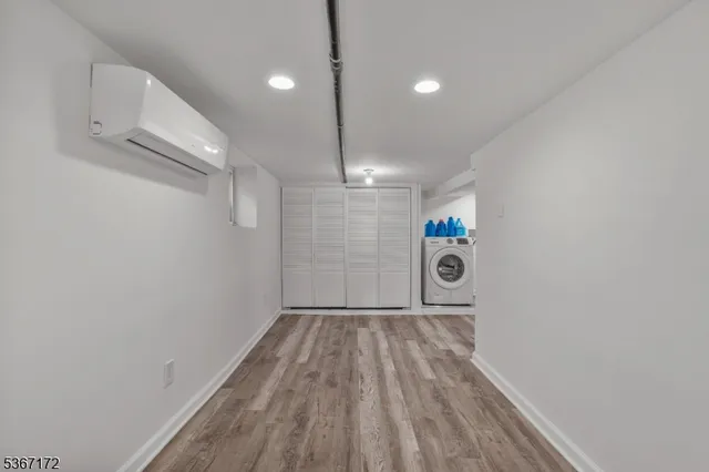 a view of a room with wooden floor ceiling fan and window
