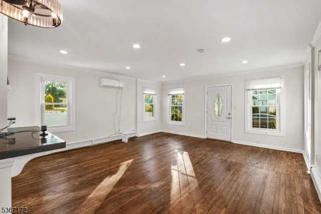 a view of a room with wooden floor and window