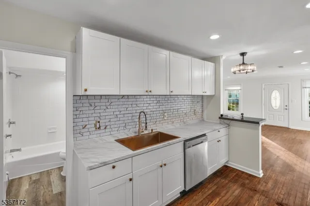 a kitchen with a sink cabinets and window