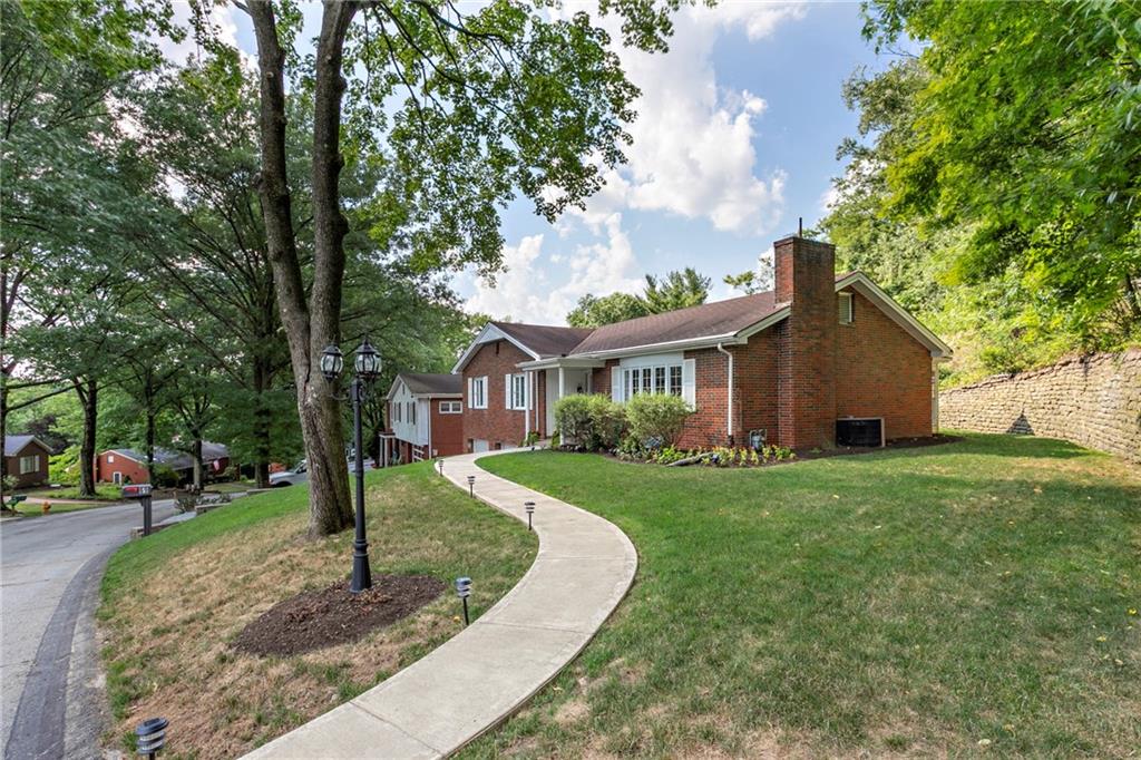 The serpentine concrete walkway, bordered with lighting, will lead visitors to your front door.  The yard is mostly flat from the front, side to the back with a gentle slope to the roadway.