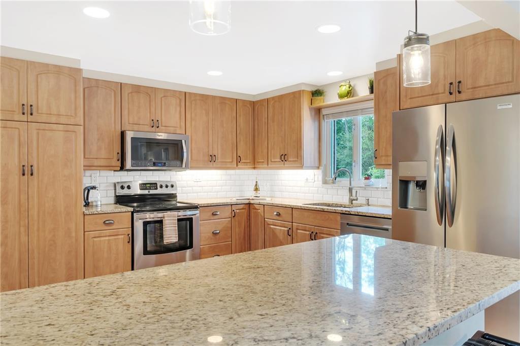 69 Holland Road Pittsburgh, PA 15235 - Photo 12 of 25 At the left of the kitchen is a pantry that has pull out shelving. The recessed lighting was reconfigured. All the hardware on the doors and drawers has been changed. A white subway tile backspace was installed..