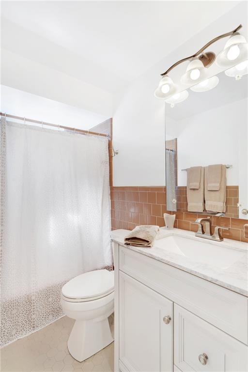 69 Holland Road Pittsburgh, PA 15235 - Photo 19 of 25 The hallway full bathroom has new lighting, vanity, countertop, sink, faucet assemble , shower head and commode