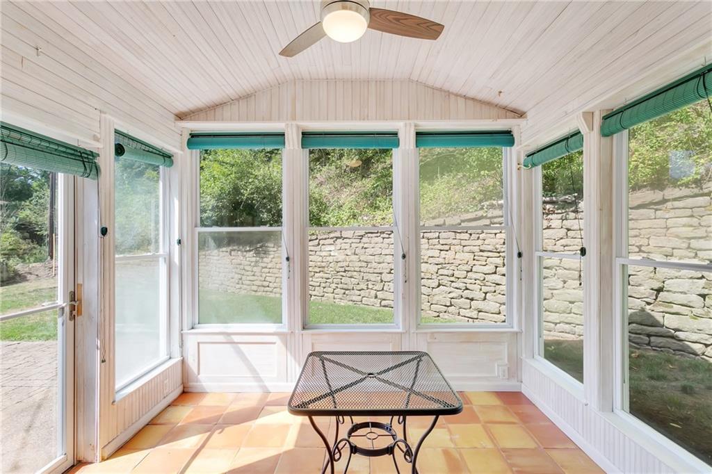 69 Holland Road Pittsburgh, PA 15235 - Photo 23 of 25 Located in the backyard, the 12x8 sunroom can be a cozy spot to relax. It's doorway exits onto a brick patio. There is a new ceiling fan to assist air circulation.