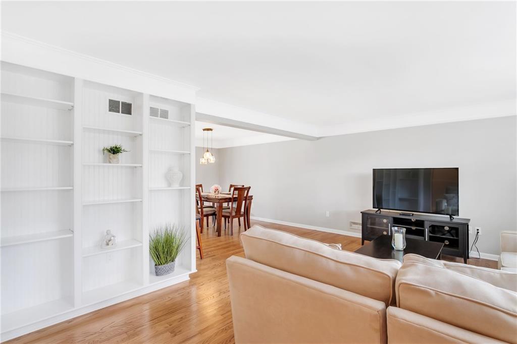The living room has shelving on both sides where you can place your favorite books, family/friend photos and sentimental momentos.
