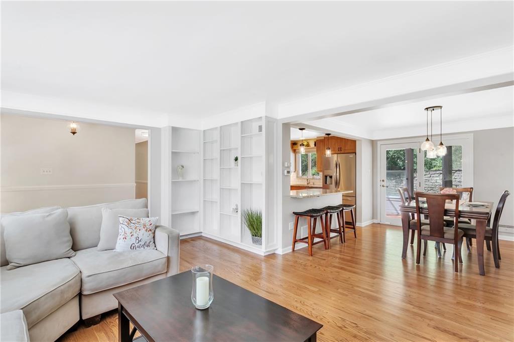 Great view of the open floor concept between the living room, dining room and the kitchen.  New lighting fixtures is in the dining room.