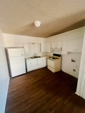 a view of a kitchen with wooden floor