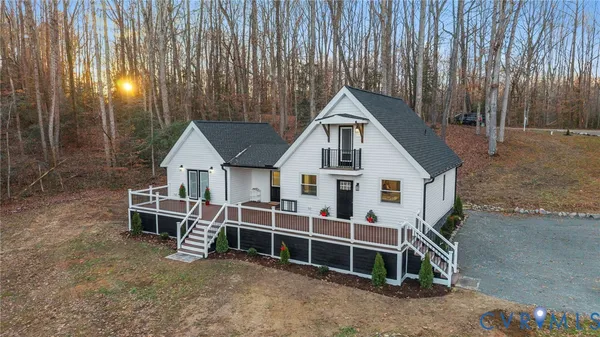 a view of a house with a yard and deck