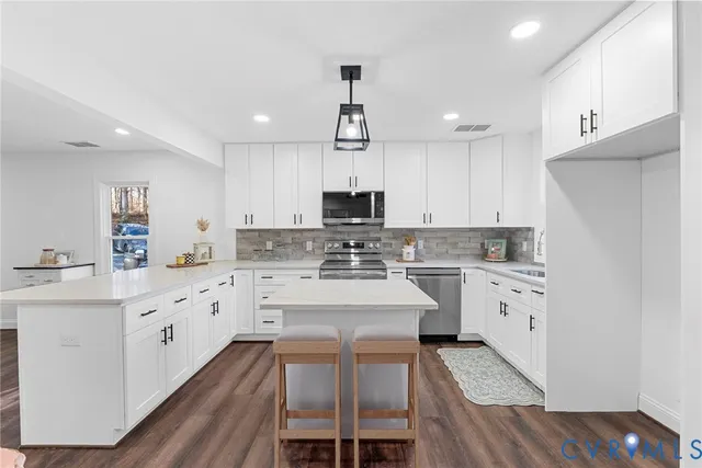 a kitchen with granite countertop white cabinets and white appliances