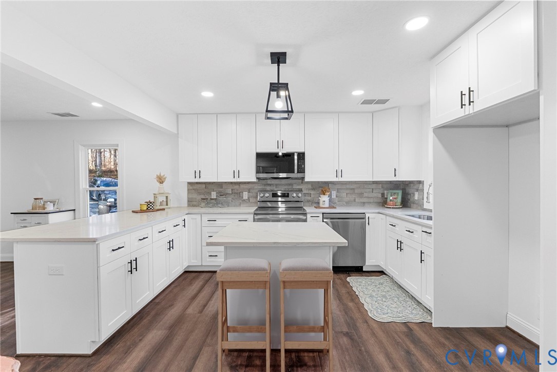 6329 Orchard Road New Kent, VA 23124 - Photo 13 of 25 a kitchen with granite countertop white cabinets and white appliances