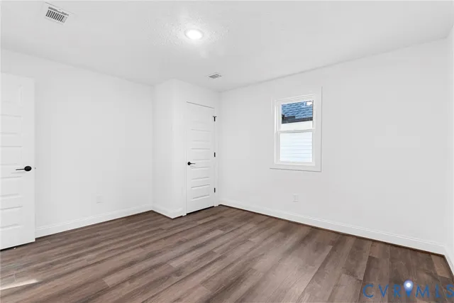 a view of a room with wooden floor and white walls