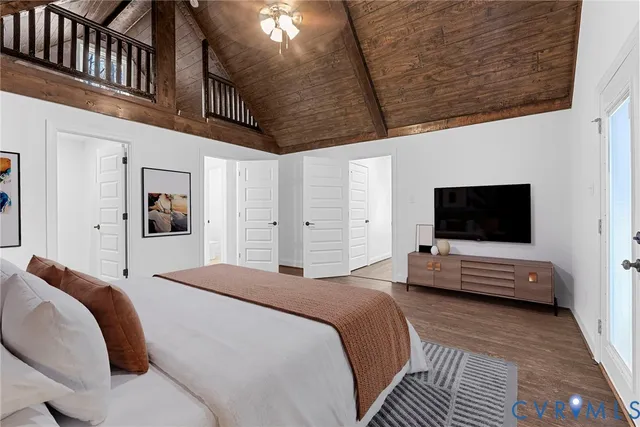 a bedroom with a bed a flat screen tv and a couch