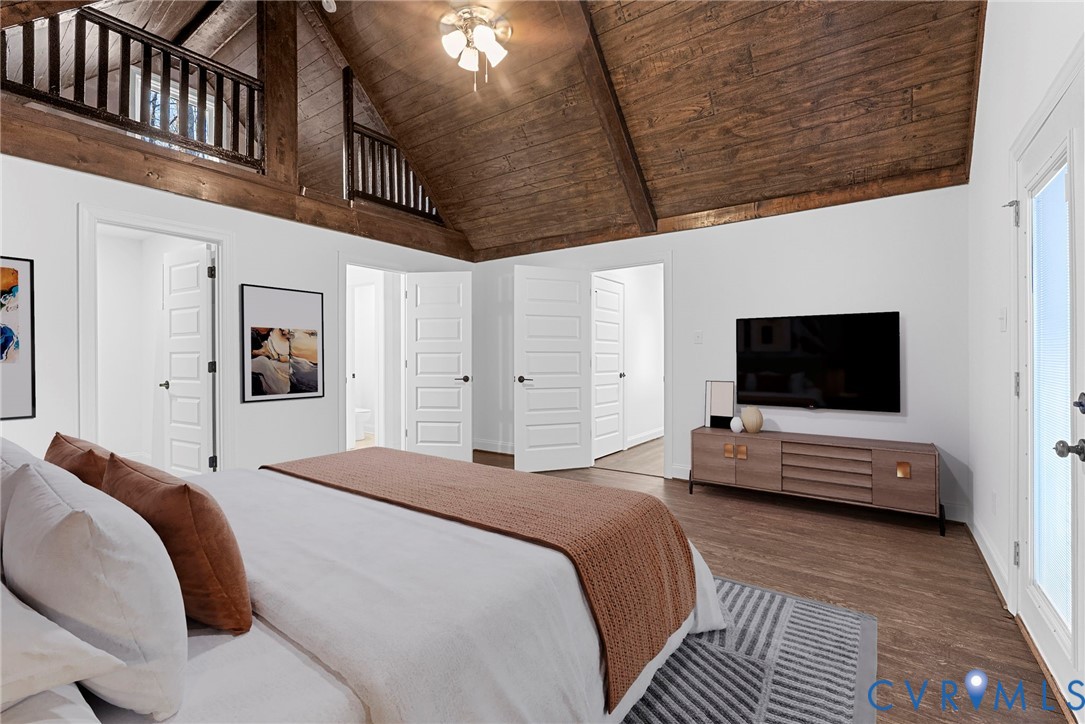 6329 Orchard Road New Kent, VA 23124 - Photo 18 of 25 a bedroom with a bed a flat screen tv and a couch