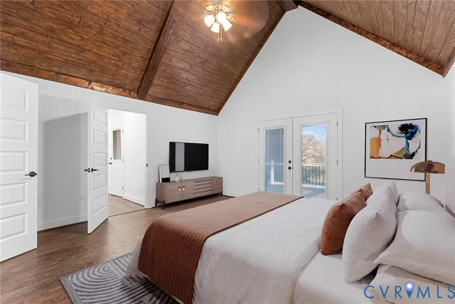 a bedroom with a large bed a flat screen tv and painting on the wall