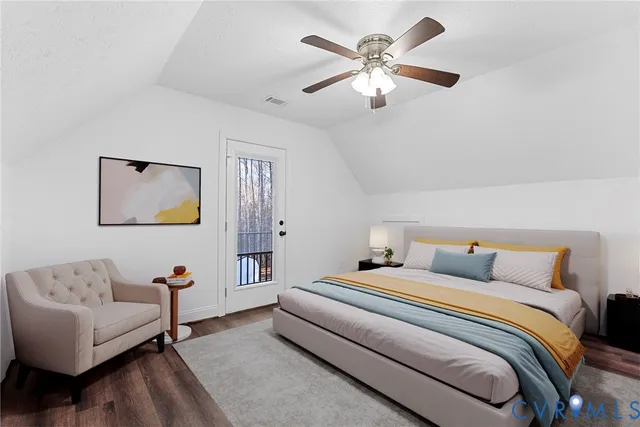 a bedroom with a large bed couch and a window