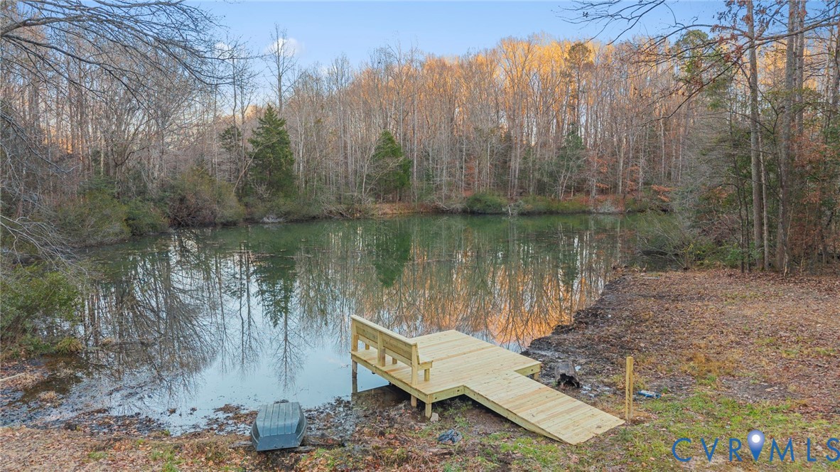 6329 Orchard Road New Kent, VA 23124 - Photo 8 of 25 a view of a lake with a house in the background