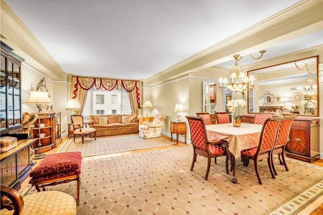 a dining room with furniture and a large window