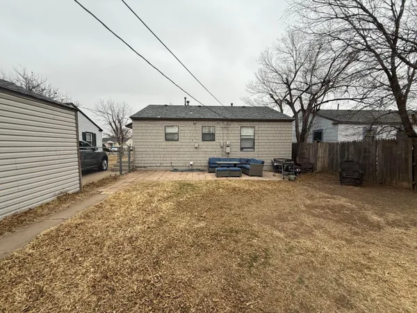 a view of a house with a yard covered in snow