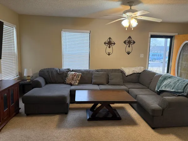 a living room with furniture a couch and a window