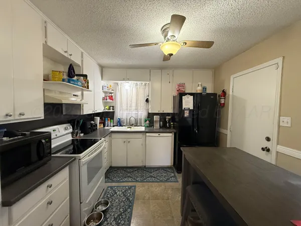 a kitchen with a sink stove and refrigerator