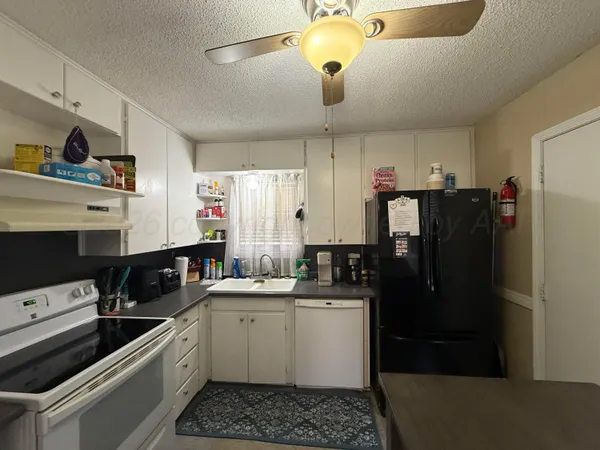 a kitchen with a sink stainless steel appliances and cabinets