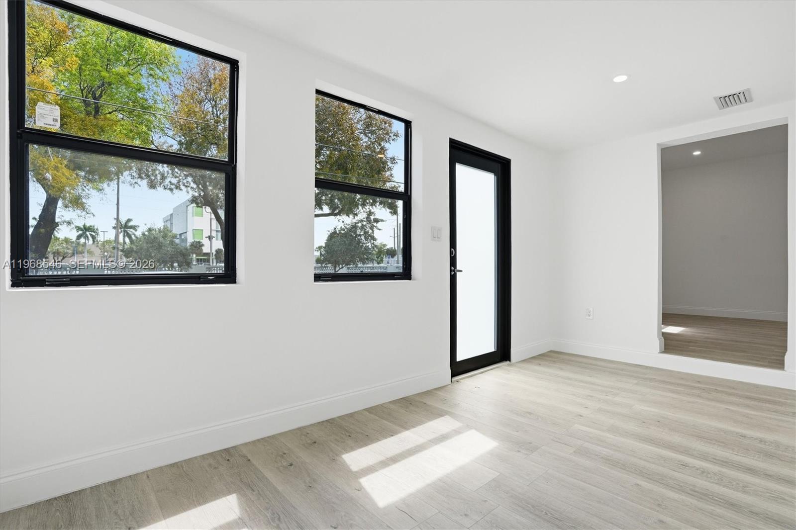 4237 Southwest 7th Street Miami, FL 33134 - Photo 6 of 31 a view of an empty room with wooden floor and a window