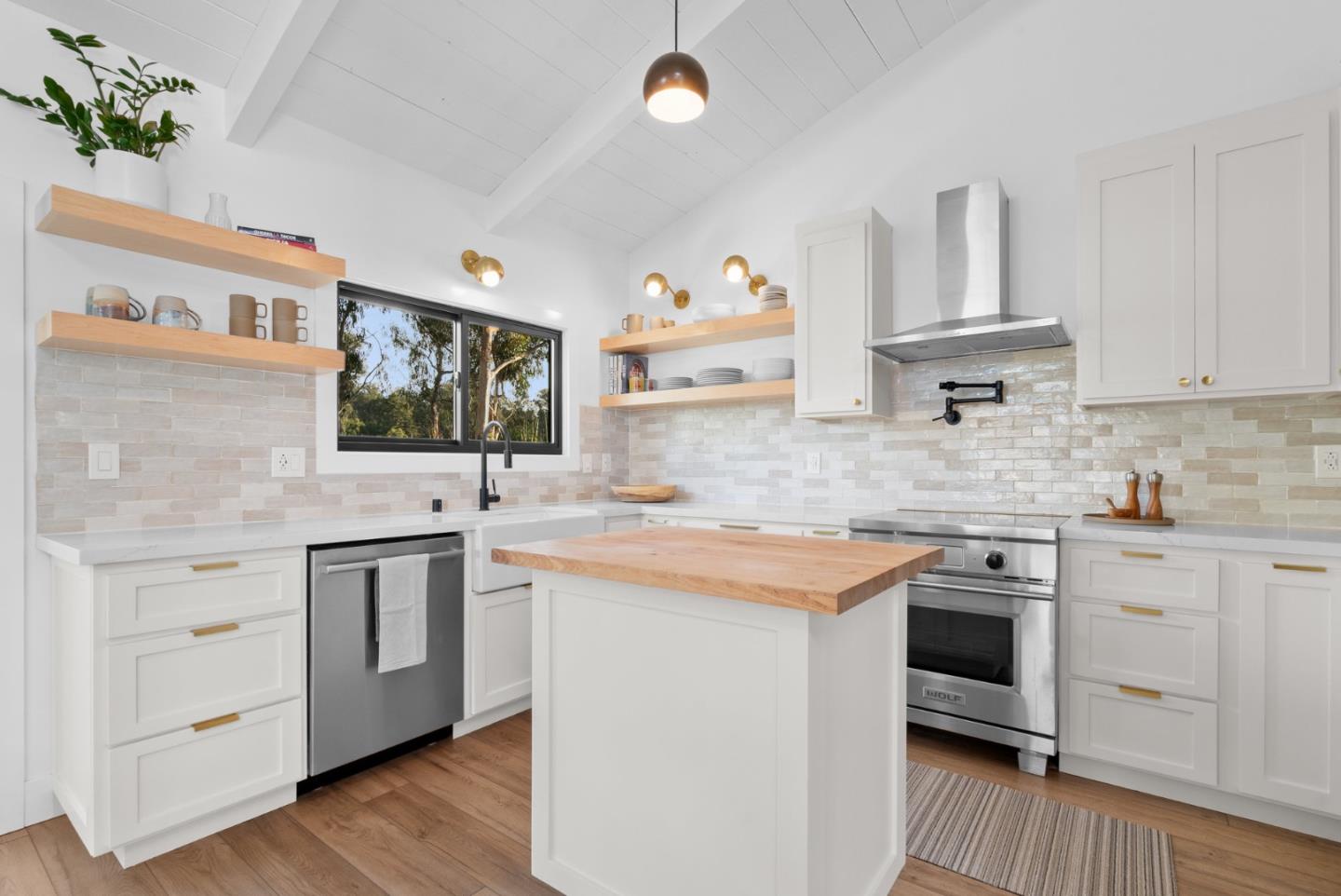 409 Townsend Drive Aptos, CA 95003 - Photo 16 of 43 a kitchen with stainless steel appliances granite countertop a sink and cabinets with wooden floor