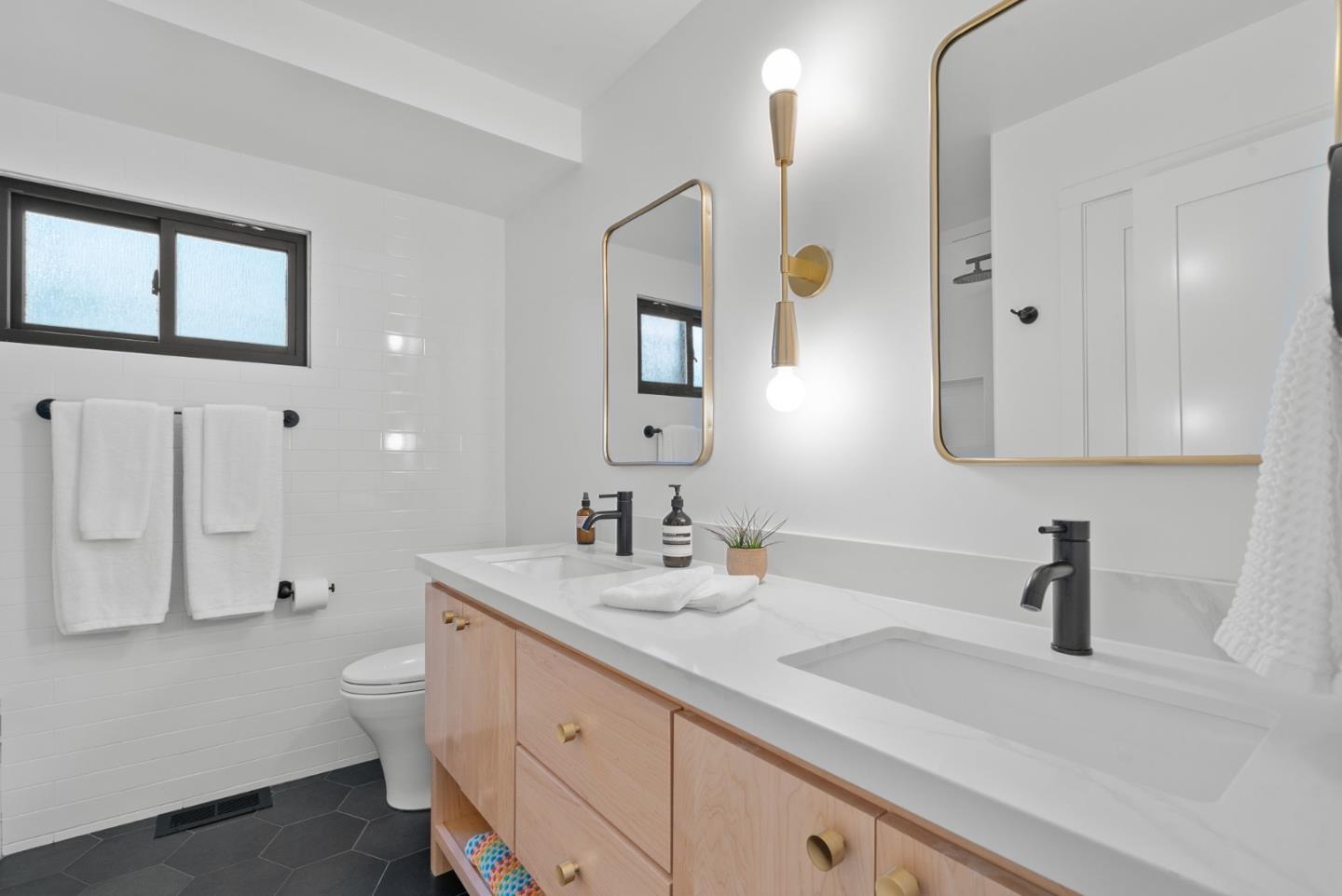 409 Townsend Drive Aptos, CA 95003 - Photo 27 of 43 a bathroom with a double vanity sink toilet and mirror