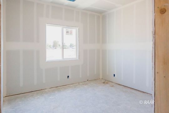 1037 Ocean Avenue Ridgecrest, CA 93555 - Photo 7 of 12 an empty room with windows and closet
