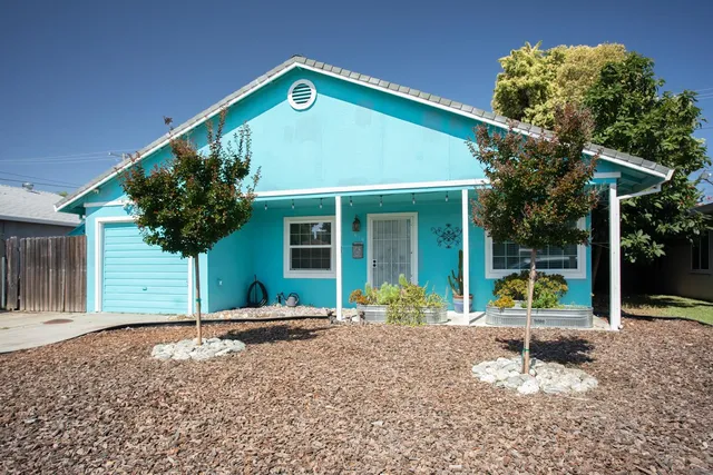 a front view of a house with garden
