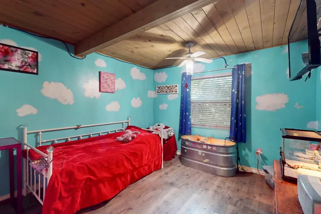 a bed sitting in a room next to a window