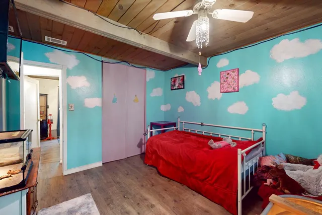 a bed room with a bed and a chandelier