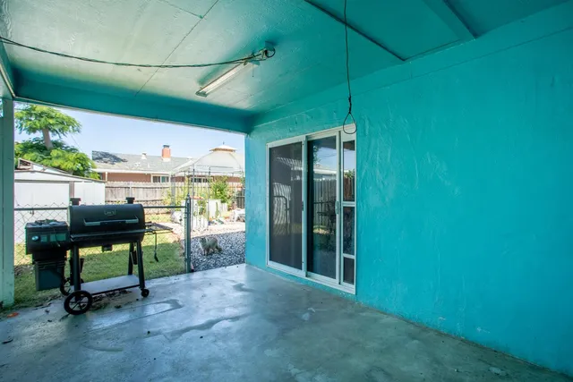 a view of a chairs and table in backyard