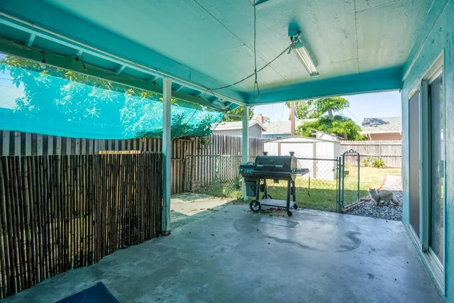 a view of backyard with a table and chairs