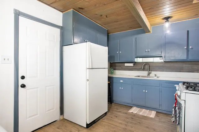 a kitchen with refrigerator a sink and cabinets