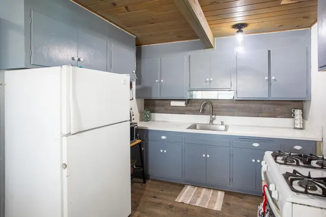 a white refrigerator freezer sitting inside of a kitchen