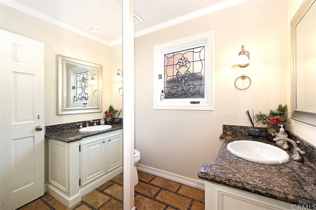 7 Windsor Newport Beach, CA 92660 - Photo 18 of 40 a bathroom with a granite countertop sink a mirror and a window