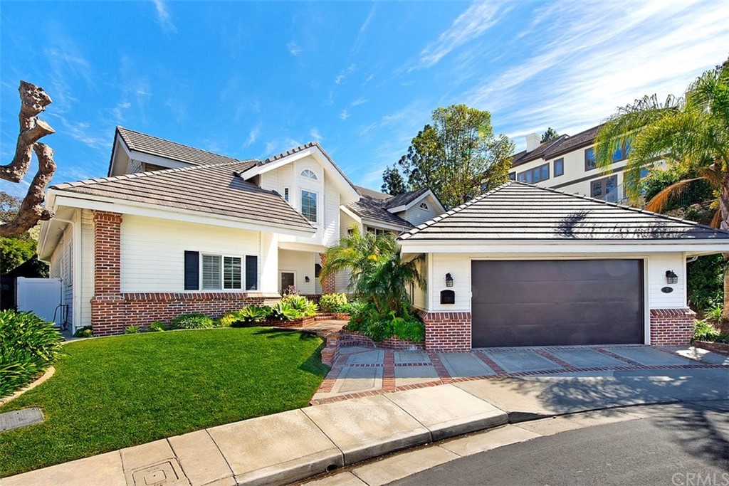 7 Windsor Newport Beach, CA 92660 - Photo 2 of 40 a front view of a house with a garden and plants