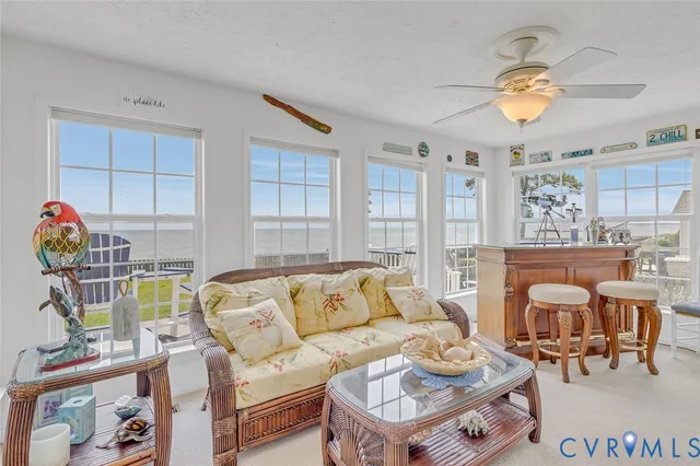 a living room with furniture a chandelier and a dining table