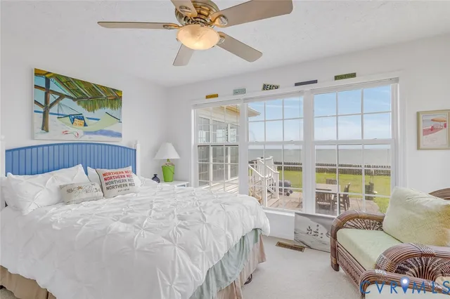 a bedroom with a bed a couch and a large window