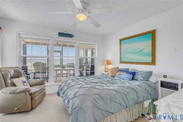 a bedroom with bed and a large window