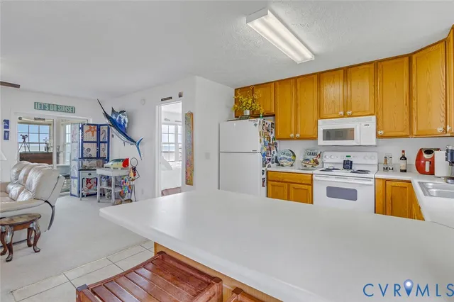 a kitchen with stainless steel appliances granite countertop a refrigerator a stove top oven a sink dishwasher and white cabinets with wooden floor