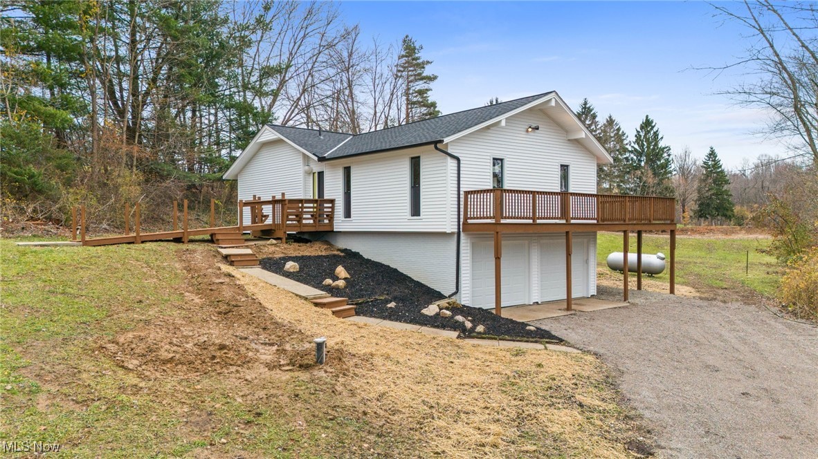 4098 State Road Medina, OH 44256 - Photo 3 of 41 View of side of home featuring a garage and a wooden deck