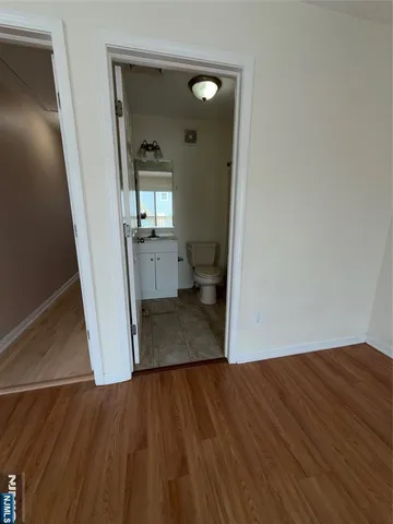 a view of a room with wooden floor and a chair