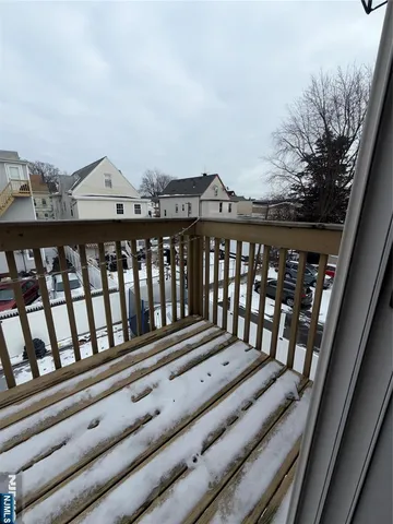 a view of a balcony with wooden floor
