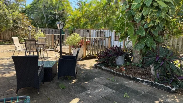 a view of a chairs and table in the patio