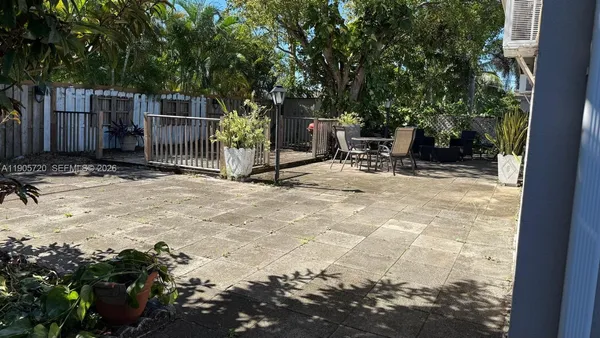 a view of backyard with deck and seating space