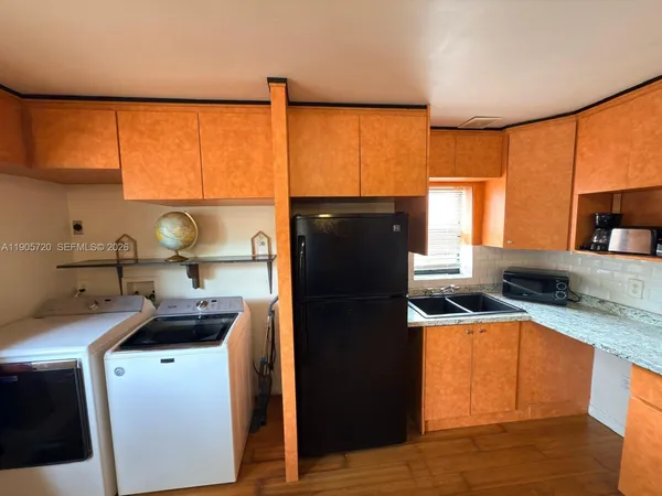 a kitchen with a sink stove and refrigerator